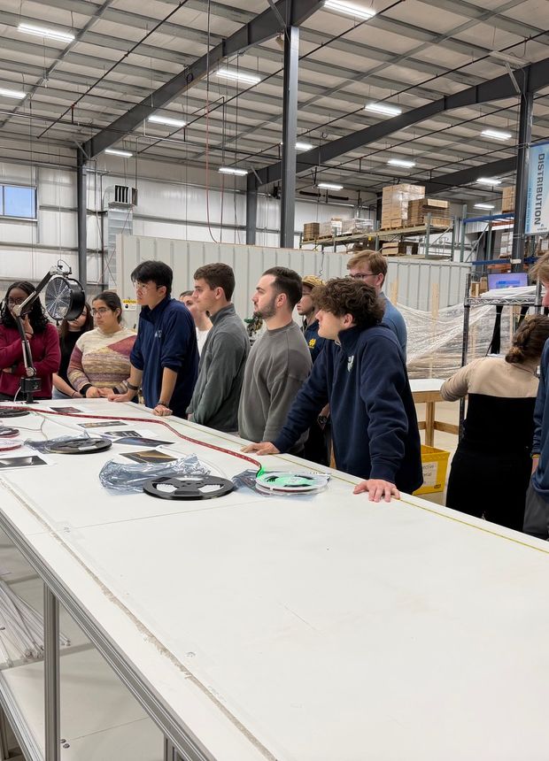 A plant manager walking the cohort through a part drawing