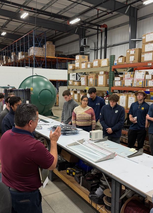 Fellows walking the production floor with an engineer